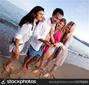 A group of friends laughing at a cellphone, funny text message or picture