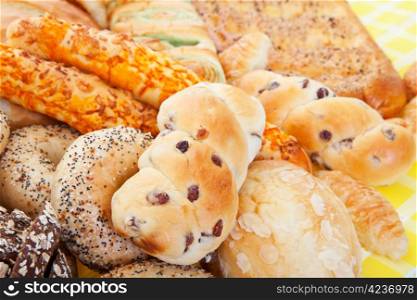 A group of international breads, including Almond Bun, Buko Pandan Loaf, Italian Cheese Sticks, & Pumpernickel.