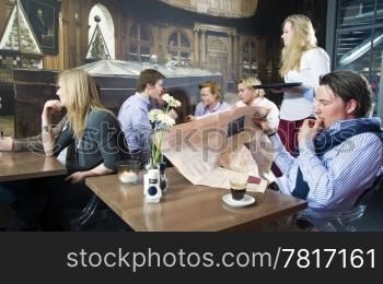 A group of people having a drink in a cafe