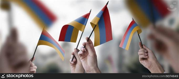 A group of people holding small flags of the Armenia in their hands.. A group of people holding small flags of the Armenia in their hands