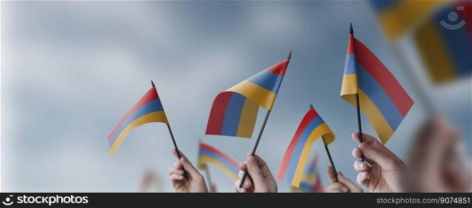 A group of people holding small flags of the Armenia in their hands.. A group of people holding small flags of the Armenia in their hands