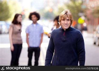 A group of people in a city setting - a caucasian male in the foreground