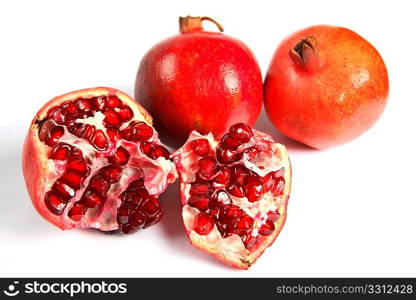 A group of ripe pomegranates over white, one broken open