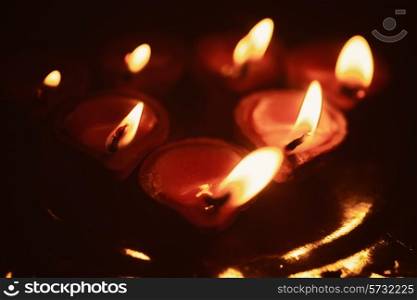A group of small candles in the dark