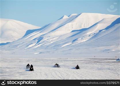 A group of snowmobiles on the ice outside Longyearbyen, Svalbard Norway