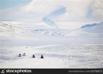 A group of snowmobiles on the ice outside Longyearbyen, Svalbard Norway