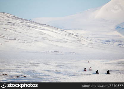 A group of snowmobiles on the ice outside Longyearbyen, Svalbard Norway