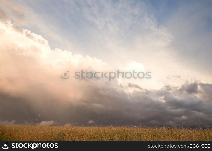 A group of storm clouds hovering above the horizon