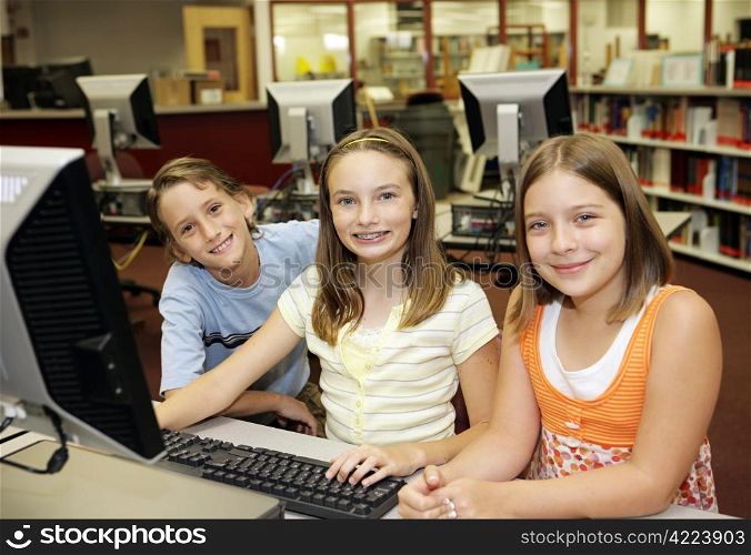 A group of students learning computers in school.