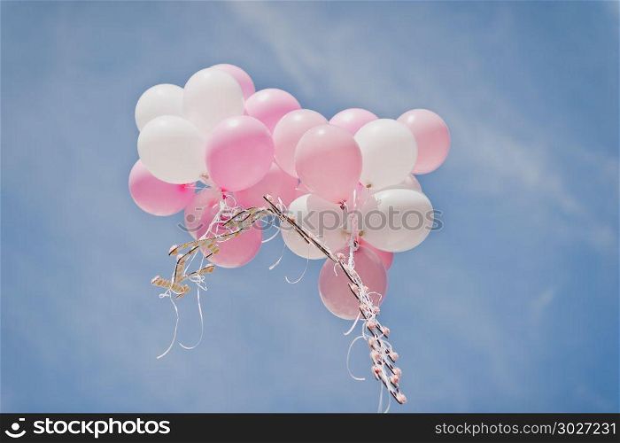 A group of white and pink balls flying into the sky.. White and pink balloons in the sky 682.. White and pink balloons in the sky 682.