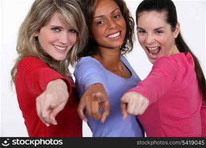 A group of young women pointing their fingers