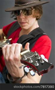 A guitarist getting the maximum from his guitar. Selective focus on the musicians left hand
