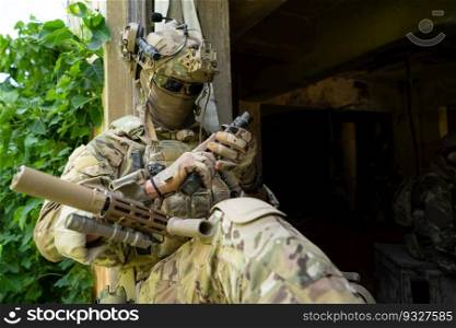 A gun, the personal weapon of a special forces soldier in camouflage, Take refuge in an abandoned building before starting a new patrol operation.