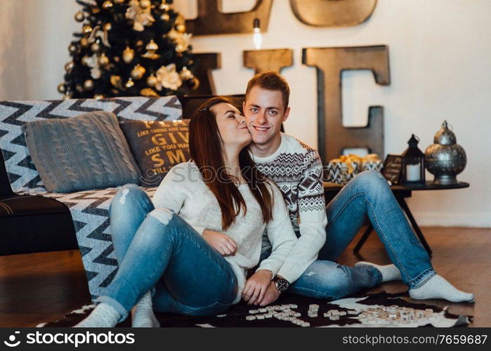 a guy and a girl celebrate the new year together
in a warm atmosphere and give each other gifts