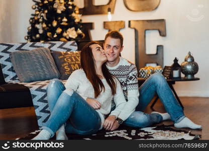 a guy and a girl celebrate the new year together
in a warm atmosphere and give each other gifts