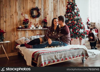 a guy and a girl celebrate the new year together
in a warm atmosphere and give each other gifts