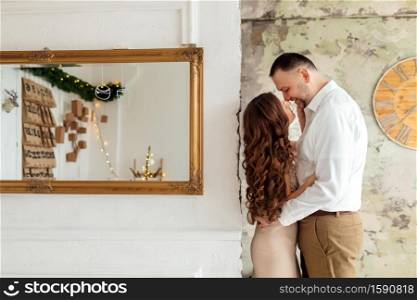 A guy with a girl is celebrating Christmas. A loving couple enjoy each other on New Year&rsquo;s Eve. young beautiful man and woman are celebrating Christmas. A loving couple enjoy each other on New Year&rsquo;s Eve.