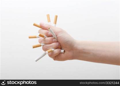 A hand crushing cigarettes