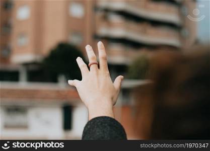A hand grabbing some rubber rings with copy space over a dark background