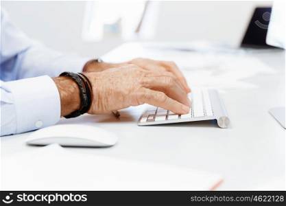 A hand of businessman with a computer mouse. Being connected and in touch