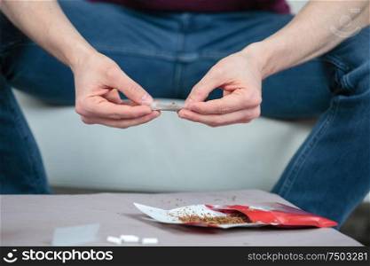 a hand rolling the cigarette