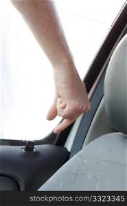 A hand unlocking a car door