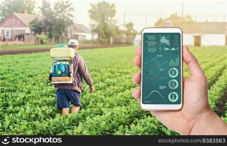 A hand with a phone on background of a farmer with agriculture smoke fog spraying machine. Crop plant care and protection from pests and fungal infection. Control of use of chemicals growing food.