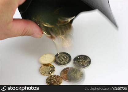 . a hand with a wallet and a few coins. inflation and debt