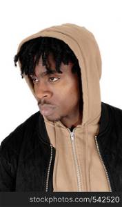 A handsome black man in a beige hoody and black jacket in close uplooking serious sideward, isolated for white background