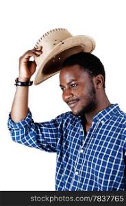 A handsome black man in a blue shirt lifting his cowboy hat and smilingisolated for white background.