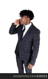 A handsome black man in a suit standing and talking on his cell phonelooking side wards, isolated for white background