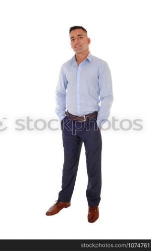 A handsome east Indian man standing in dress pants and a blue shirt relaxed in the studio, smiling, isolated for white background
