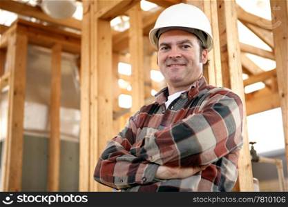 A handsome, friendly construction worker on the job site. Authentic construction worker on actual construction site.