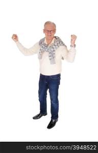 A handsome senior man in a sweater and jeans lifting both arms in victory,standing isolated for white background.