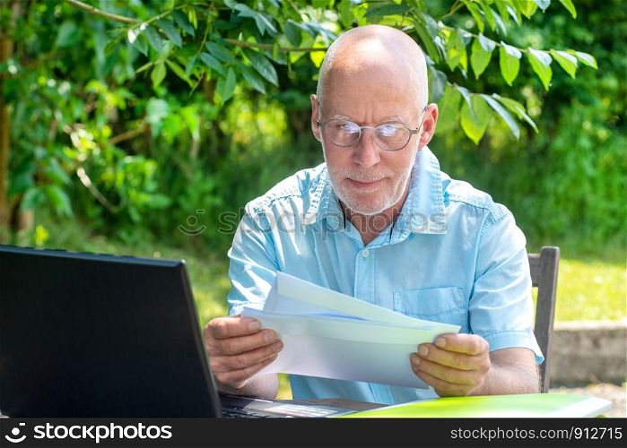 a handsome senior man reading the letter