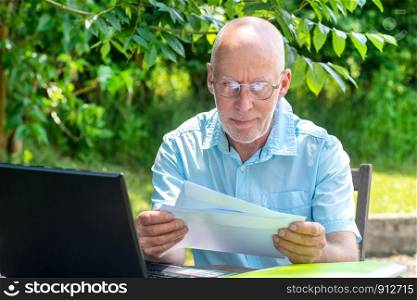 a handsome senior man reading the letter