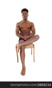 A handsome young African American man sitting in black underwear ona chair, looking serious, isolated for white background.