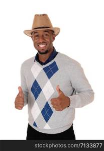 A handsome young African American man standing with his thumps up in a sweater and cowboy hat, isolated for white background