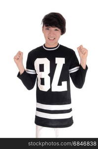 A handsome young Asian teenager standing in a black t-shirt with his fists up, celebrating victory, isolated for white background.