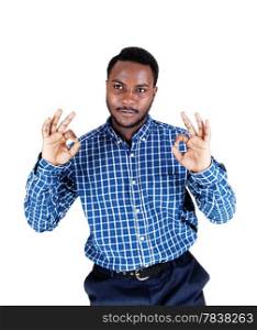 A handsome young black man in a blue shirt with his arms up andshowing the victory sign, isolated for white background.