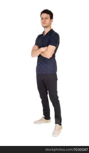 A handsome young man in a black sweater and jeans standing with his arms folded, looking into the camera, isolated for white background