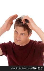 A handsome young man in a burgundy shirt brushing his hair,isolated for white background.