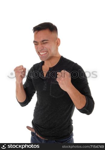 A handsome young man is happy he got what he wants by making fist?s with booths hands and eyes closed, isolated for white background