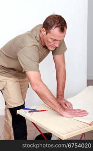 a handyman bending a covering