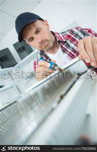 a handyman fixing a radiator
