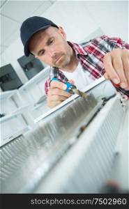 a handyman fixing a radiator