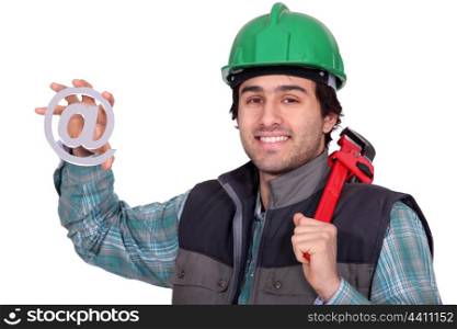 A handyman holding a at sign.