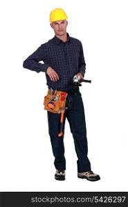 A handyman holding a power tool.