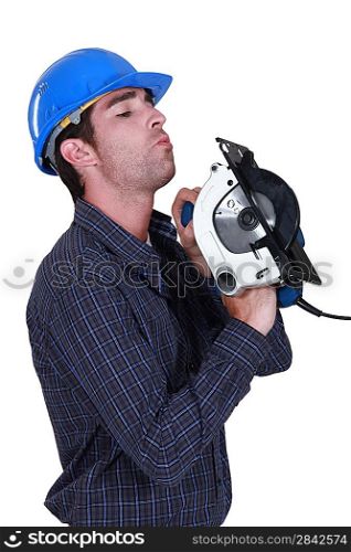 A handyman inspecting his circular saw.