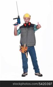 A handyman with a drill giving the thumb up.